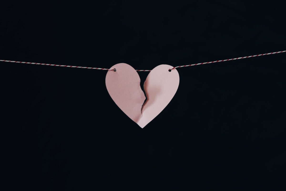 paper cutout of a broken heart hanging on wire after divorce.
